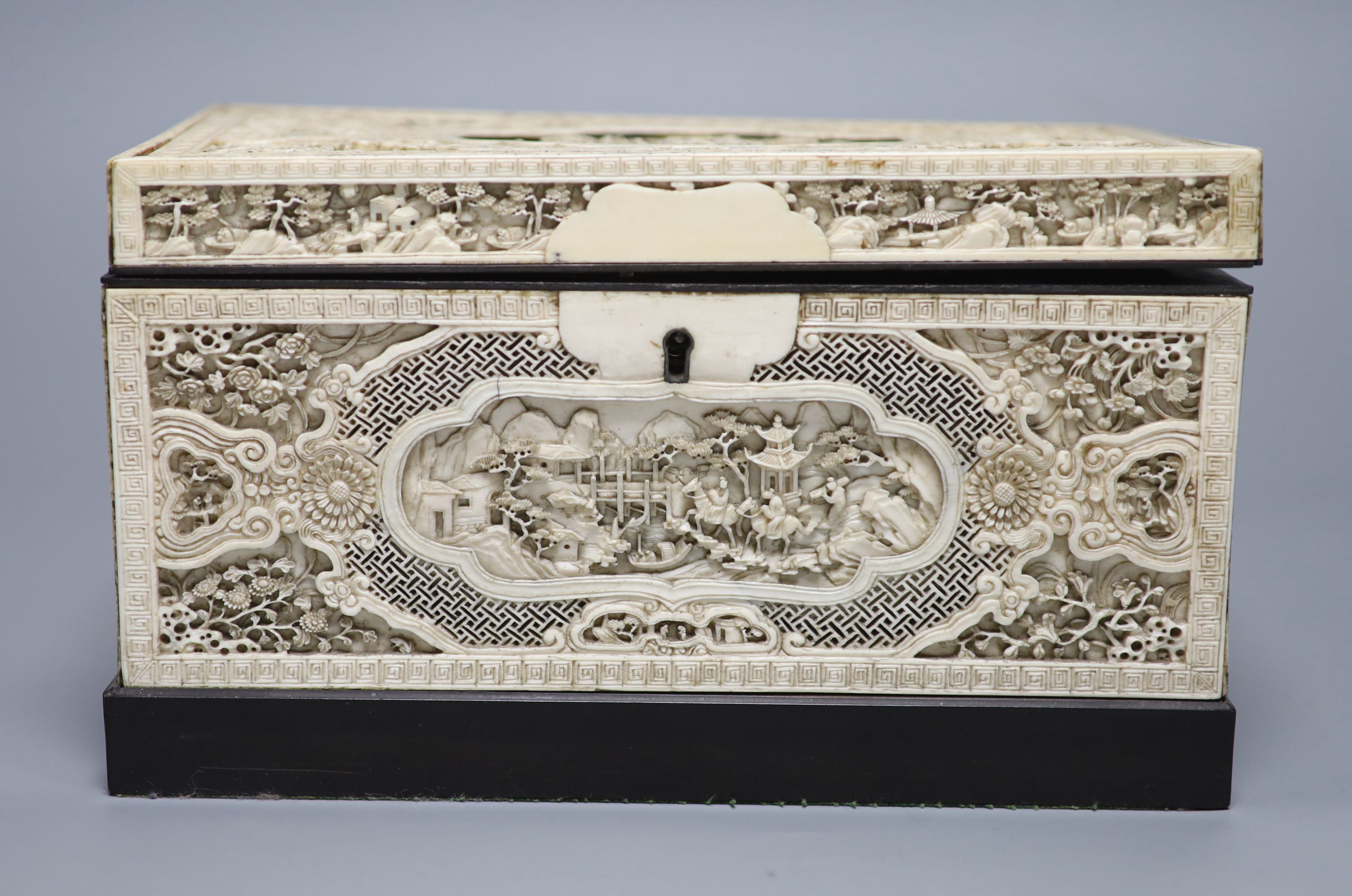 A good pair of George II embossed silver tea caddies and covers, by Elizabeth Godfrey, London, 1749/50, housed in a later 19th century pierced Canton ivory mounted caddy, with velvet interior